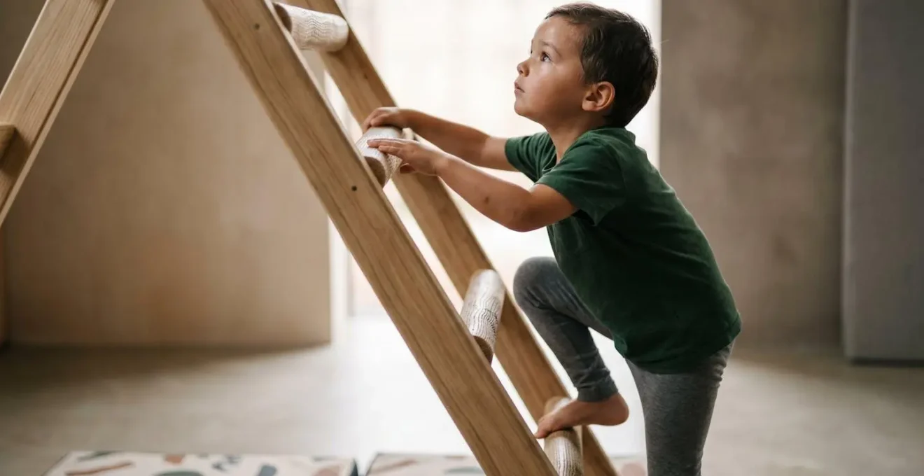 Young child engaged in physical climbing activity demonstrating focus and body control