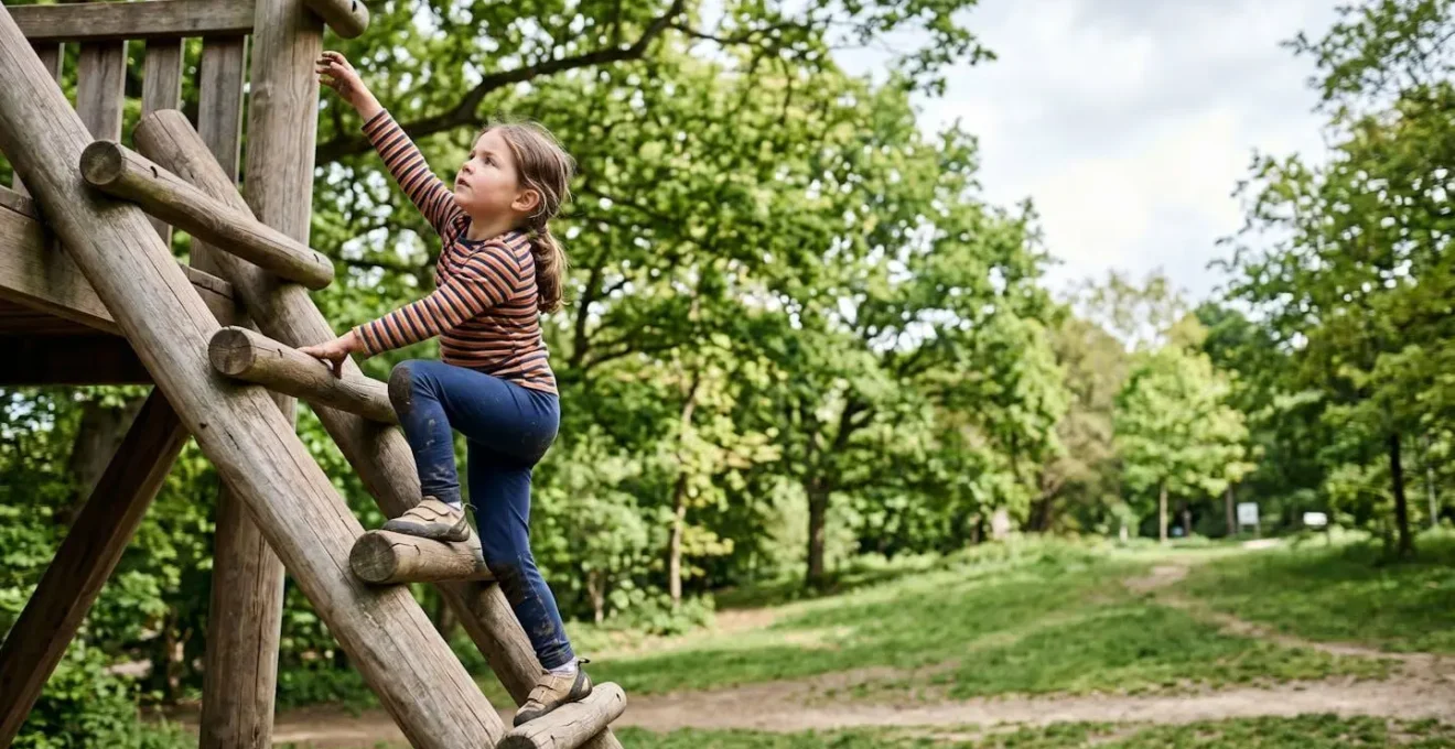 Child engaged in active climbing play demonstrating proprioceptive input and physical confidence