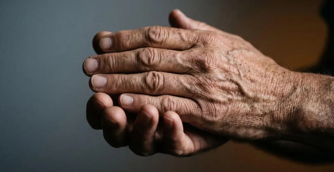 Close-up of hands in reflective gesture showing vulnerability and strength during difficult moment